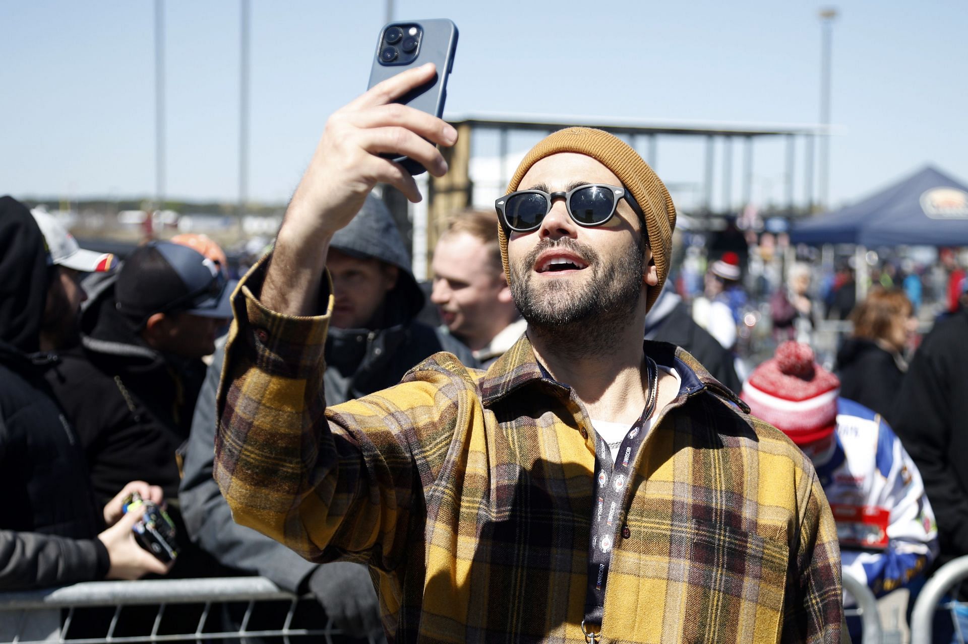 Fan checks his phone during event